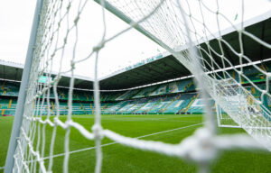An empty Celtic Park through the goal-net.