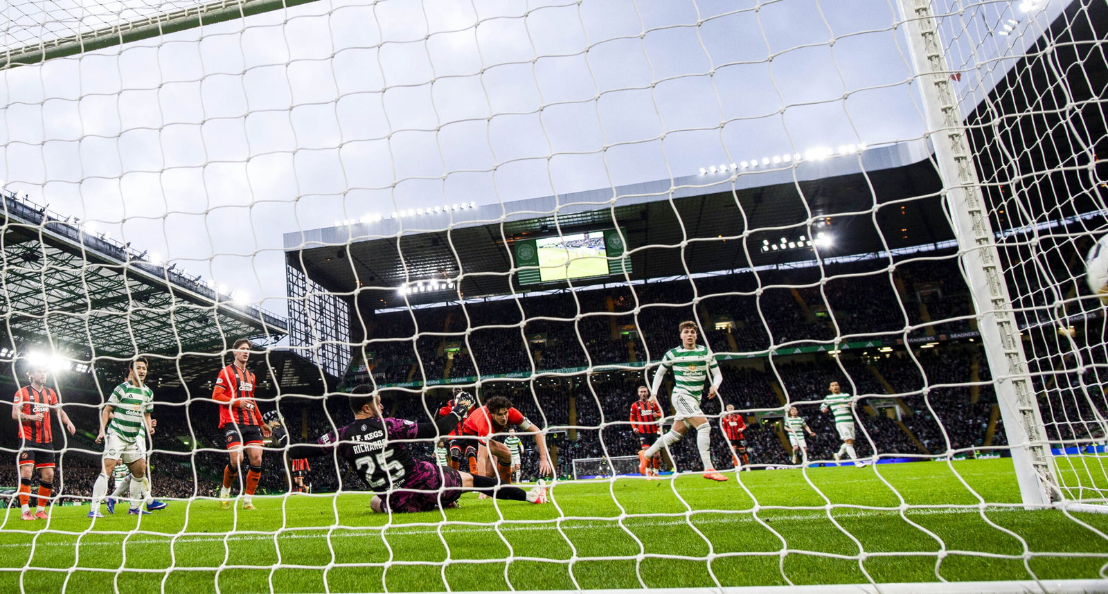 Celtic players celebrate the second goal