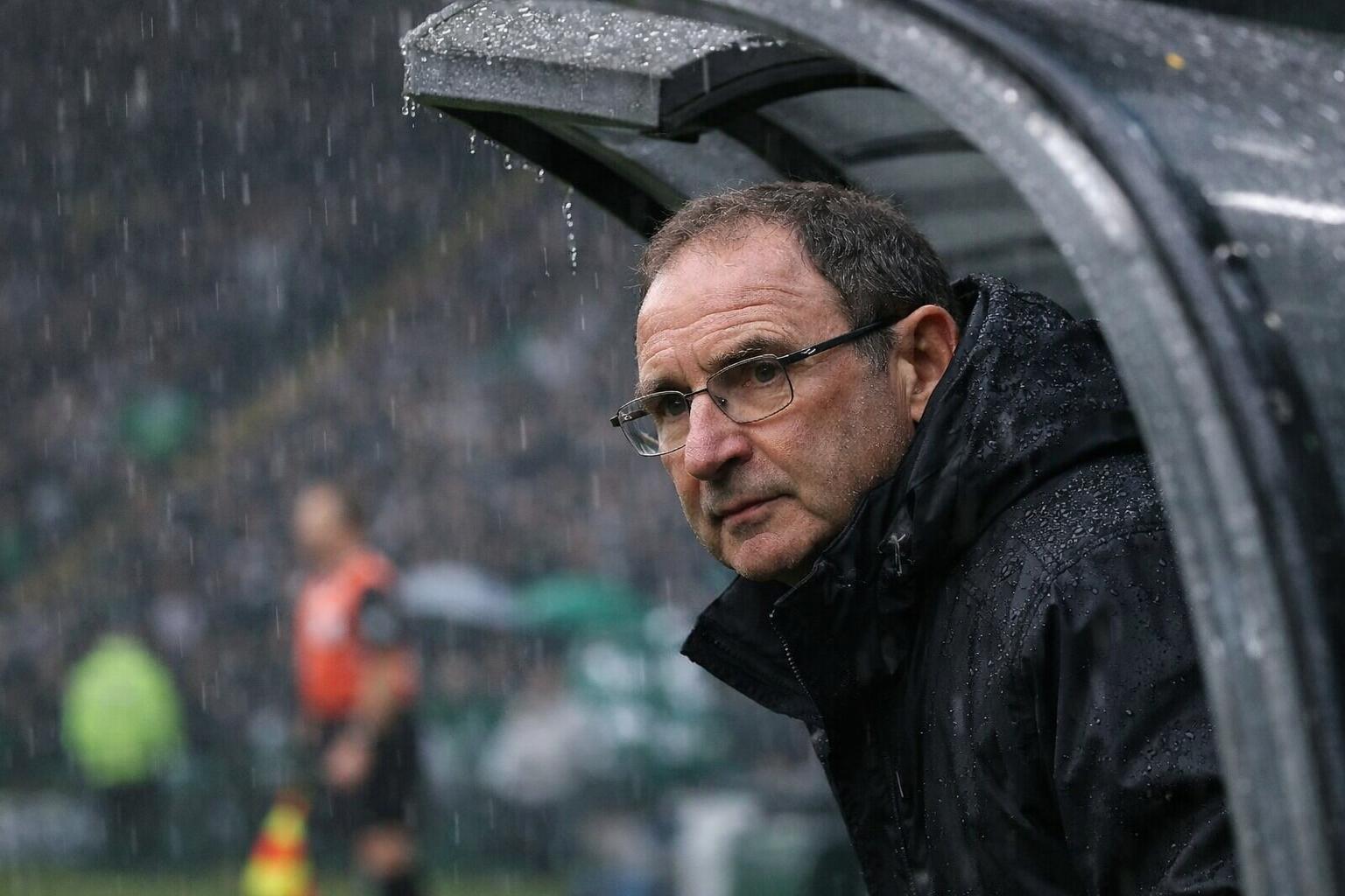 Martin O'Neill peering out of the dugout at a rainy game