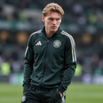 Contemplative Footballer in Green Tracksuit